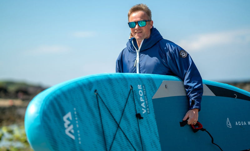 Wild & Free Cobe worn for watersports: paddleboarder on the shore